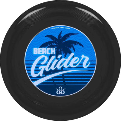Black Dynamic Discs Beach Glider ultimate frisbee with a blue palm tree and wave graphic on the underside.