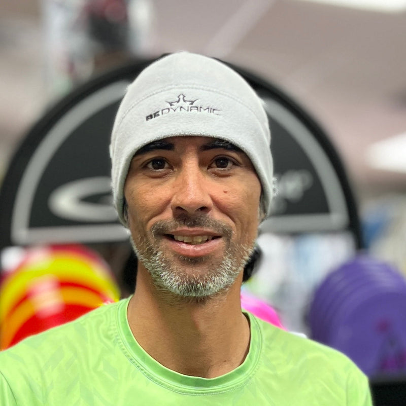 Light gray Dynamic Discs "Be Dynamic" fleece beanie with black embroidered text and a crown logo.