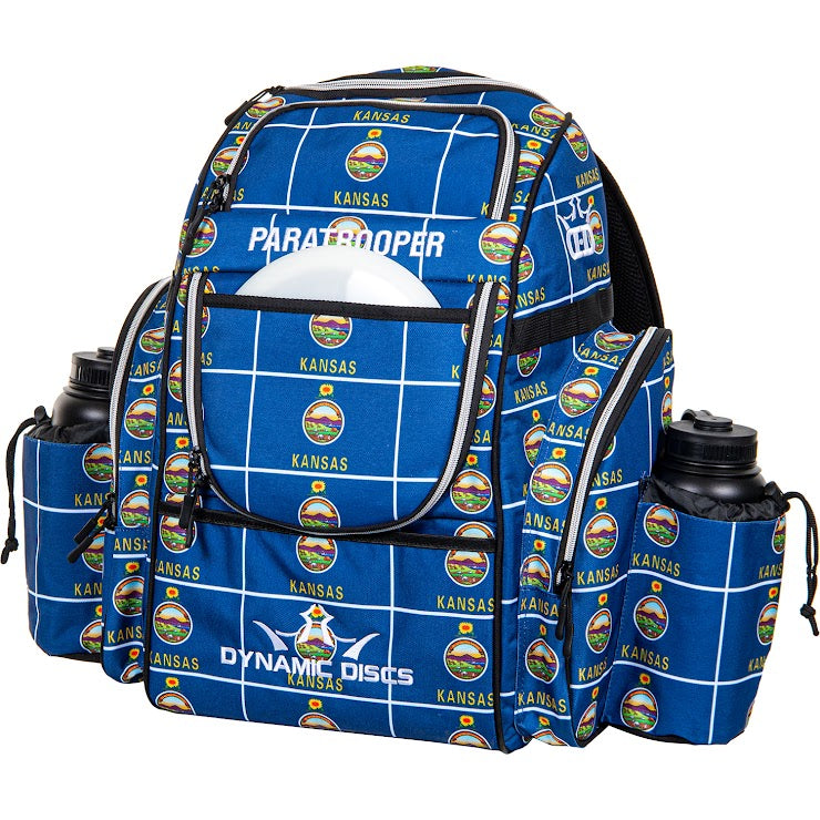 Blue Dynamic Discs Paratrooper backpack with "Kansas" and Sunflower State seals pattern, featuring two water bottles.