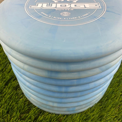 Stack of blue and white swirl Dynamic Discs Classic Blend Burst Judge putter disc golf discs.
