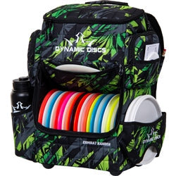 Dynamic Discs Combat Ranger disc golf backpack in a green foliage pattern, holding multiple vibrant discs.