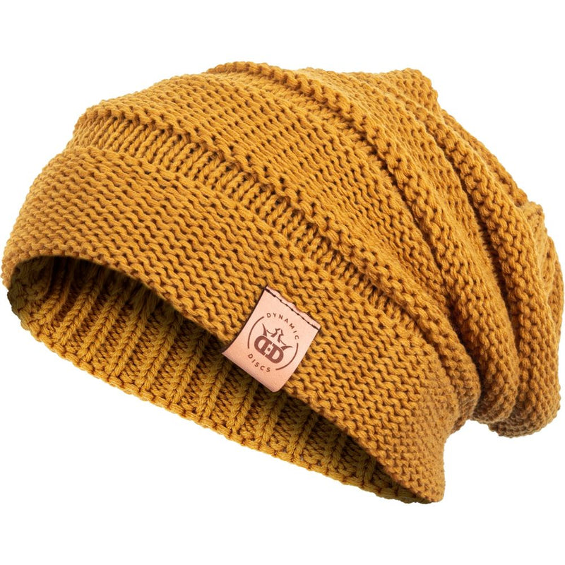 Mustard yellow knit Dynamic Discs Deluxe Slouch Scrunch Beanie with a brown leatherette brand tag on the brim.