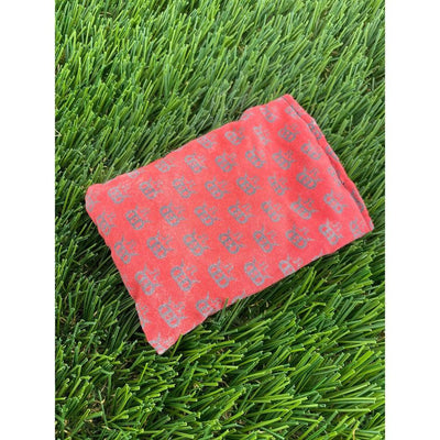 The terracotta red Dynamic Discs Dirtbag Mini King DS features a repeating gray "DD" logo pattern on textured fabric.