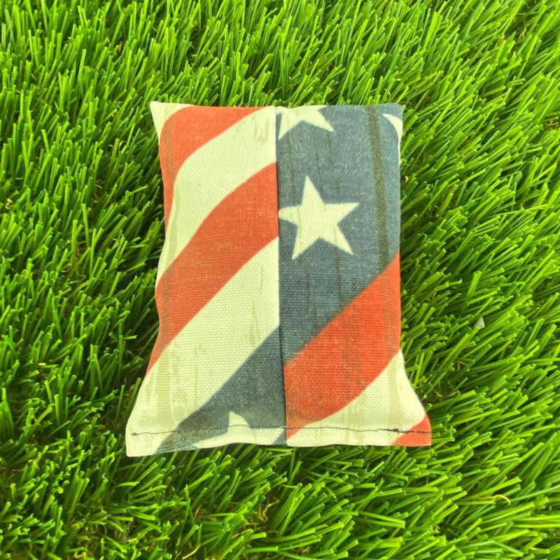 Dynamic Discs Dirtbag USA, a small fabric throw bag in a red, white, and blue American flag design.
