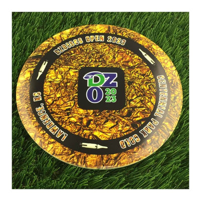 Dynamic Discs Fuzion Emac Truth disc in metallic gold with a black rim and white text and logo.