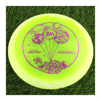 Translucent yellow Dynamic Discs Lucid-X Orbit Maverick disc with a purple Zach Melton Team Series 2024 astronaut stamp.