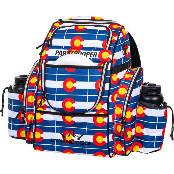 Dynamic Discs Paratrooper backpack disc golf bag with a blue, white, red, and yellow Colorado flag pattern.