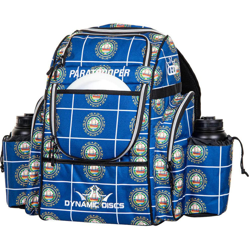 Dynamic Discs Paratrooper backpack in blue with white gridlines, repeating state seal pattern, and "Paratrooper" text.