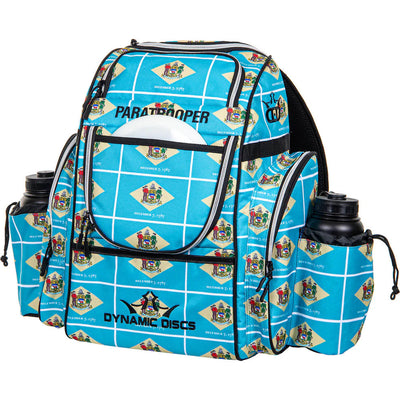 Light blue Dynamic Discs Paratrooper disc golf bag with a Delaware state flag pattern and two water bottles.