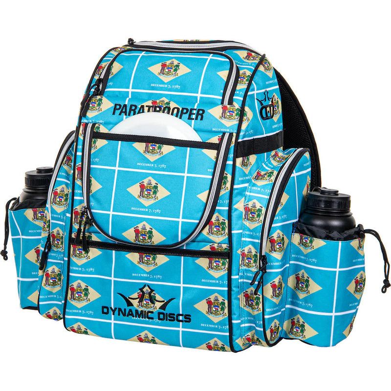 Light blue Dynamic Discs Paratrooper disc golf bag with a Delaware state flag pattern and two water bottles.