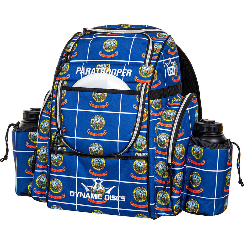 Royal blue Dynamic Discs Paratrooper backpack with a white grid pattern and circular state seal logos.