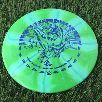 Swirled green Dynamic Discs Supreme Burst Sockibomb Felon disc with a blue Ricky Wysocki running raptor stamp.