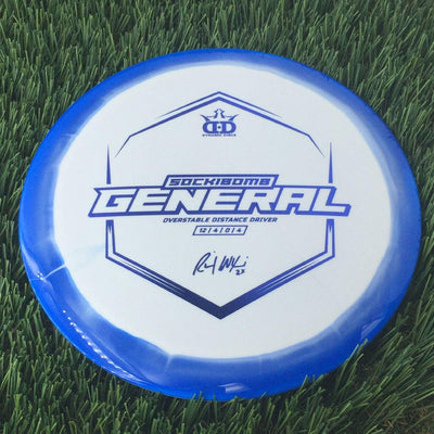 Dynamic Discs Supreme Orbit Sockibomb General, a solid blue overstable distance driver with a white center and a gold stamp.