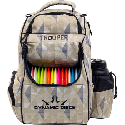 Limited edition Dynamic Discs Trooper backpack in a geometric beige, white, and gray pattern, filled with colorful discs.