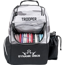 Gray and white camouflage Dynamic Discs Trooper backpack disc golf bag with colorful discs and a black water bottle sleeve.