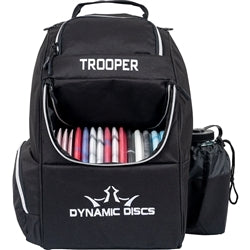 Black Dynamic Discs Trooper backpack with white trim, a large front flap disc compartment, and a bottle holder.
