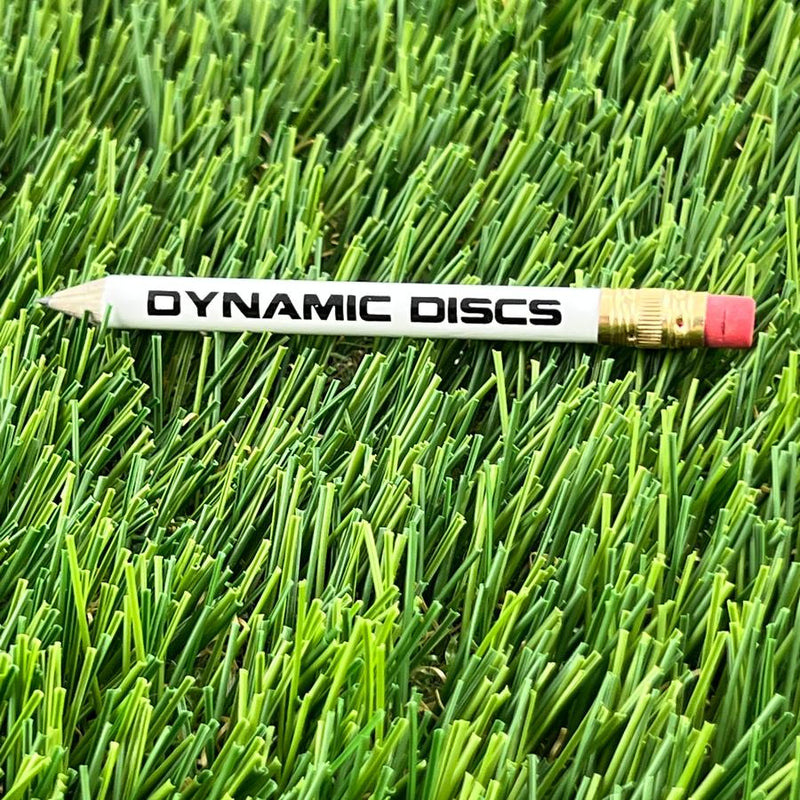 White Dynamic Discs pencil with a sharpened lead tip, a gold metal ferrule, and a pink eraser.
