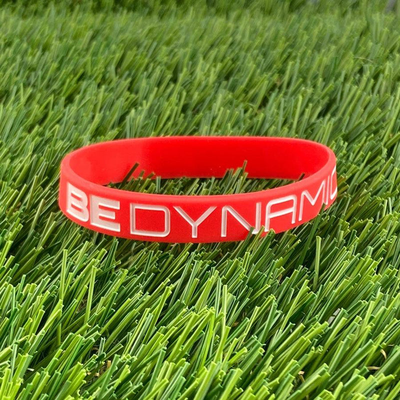 Red silicone Dynamic Discs "BE DYNAMIC" wristband with embossed white lettering.