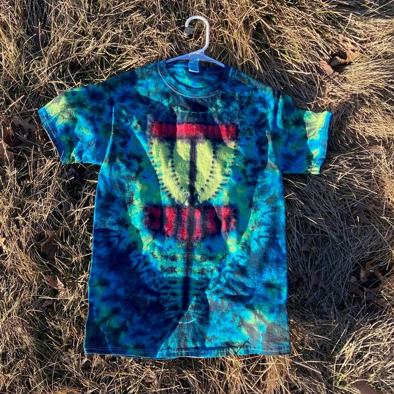 Blue and green tie-dye t-shirt with a white hanger, featuring a yellow disc golf basket graphic and red lettering.