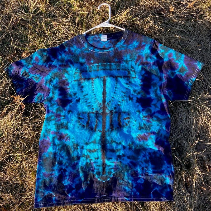 A vibrant twisted amanita mushroom basket style dysket t-shirt in varying shades of blue, teal, and deep purple.