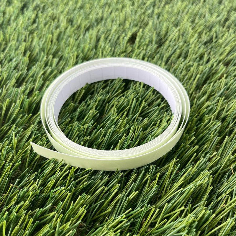 Rolled spool of dzdiscs half-inch wide glow tape, featuring a pale yellow tape strip and white adhesive backing.