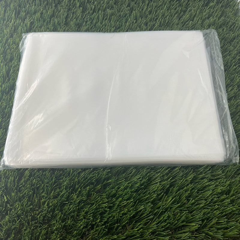 Clear 4 mil poly bags for single discs, folded and stacked on a vibrant green surface.