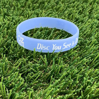 Light blue silicone wristband with white "OZ discs" logo and "Disc You See is..." text embedded on the surface.