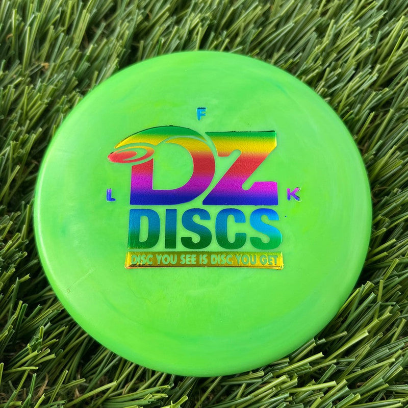 Bright lime green DZ Discs mini marker disc with a rainbow metallic logo and text stamped on its surface.