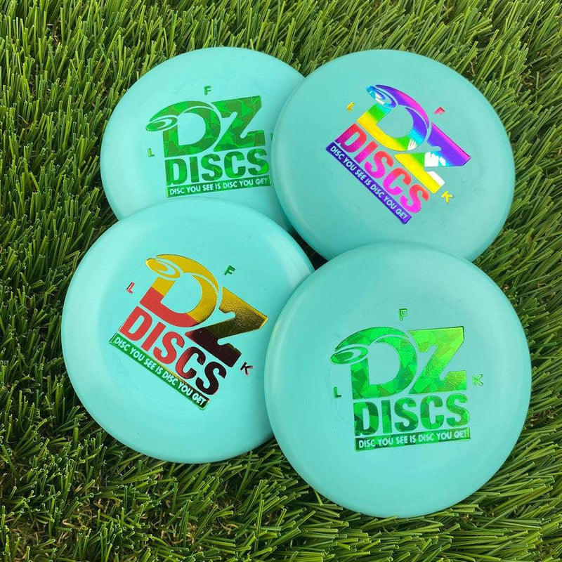 Four light blue dzdiscs mini marker discs, each with a different colored "DZ DISCS" logo printed on top.