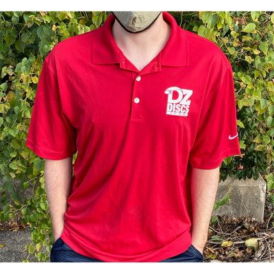 Red Nike Dri-FIT micro pique polo with a white DZ Discs Team logo and a small white Nike swoosh on the sleeve.