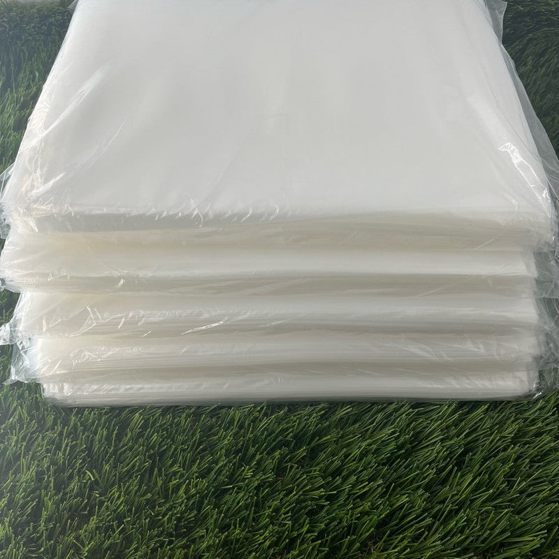 Stacked transparent, 4 mil polyethylene bags for discs, measuring 9 by 12 inches individually.
