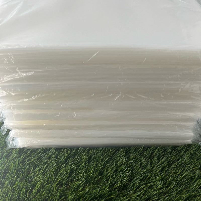 A stack of translucent white 4 mil poly bags for disc golf discs, shown unwrapped and ready for use.