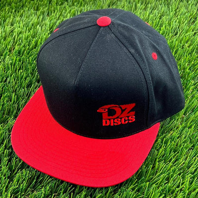Black DZ Discs Yupoong flat bill snapback cap with a red brim and red embroidered DZ Discs logo.
