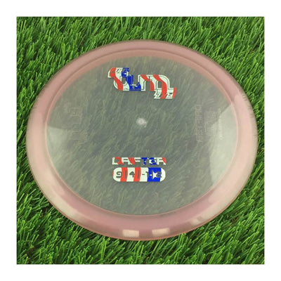 Translucent mute pink Full Turn Priority Drifter disc golf disc with a unique red, white, and blue stamp.