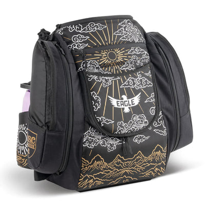 Black GRIP EQ AX5 Valhalla disc golf bag with a gold and white eagle, sun, clouds, and mountain design.