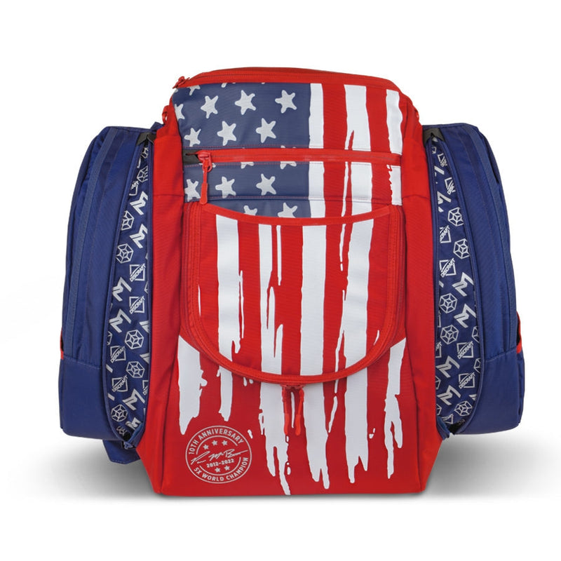 Red, white, and blue GRIP EQ AX5 Paul McBeth 10-year anniversary disc golf bag with zippered pockets.