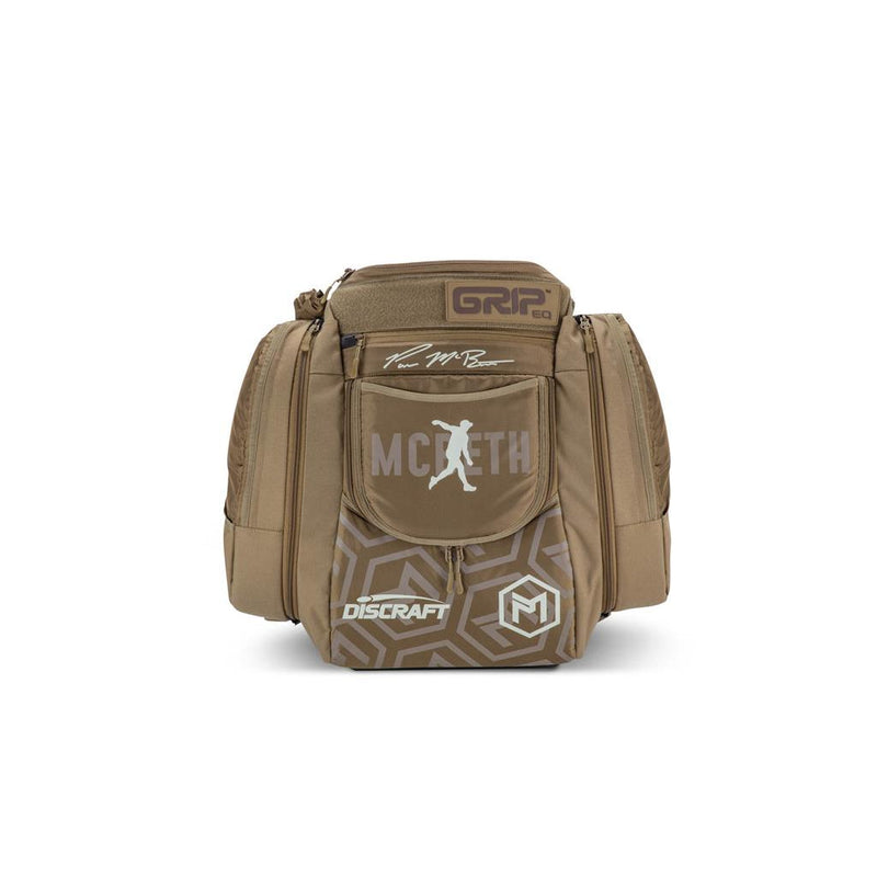 Tan GRIP EQ AX5 Paul McBeth tour bag backpack with "McBeth" and Discraft logos in white.