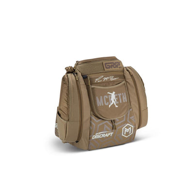 Brown GRIP eq AX5 Series backpack with Paul McBeth's signature and the Discraft logo.