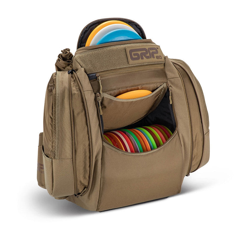 Tan Grip EQ AX5 Series Tour Bag backpack with multiple zippered pockets and colorful discs visible.