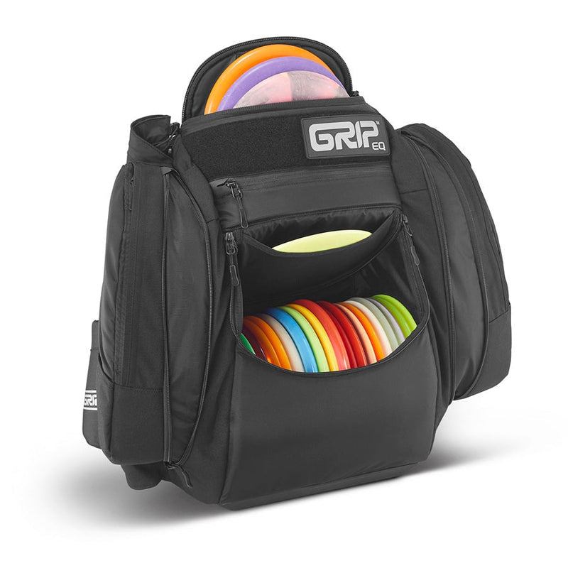 Black GRIP EQ AX5 Series Tour Bag backpack filled with various colorful disc golf discs.