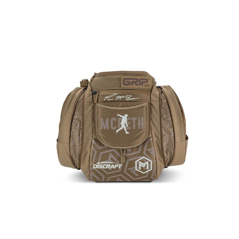 Brown Grip EQ AX5 Series Tour backpack with a geometric pattern, Paul McBeth signature, and Discraft logo on the front.