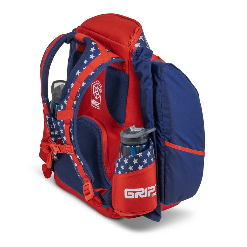 Red and blue GRIPeq AX5 Series Tour Bag backpack with white stars, shoulder straps, and two water bottles.