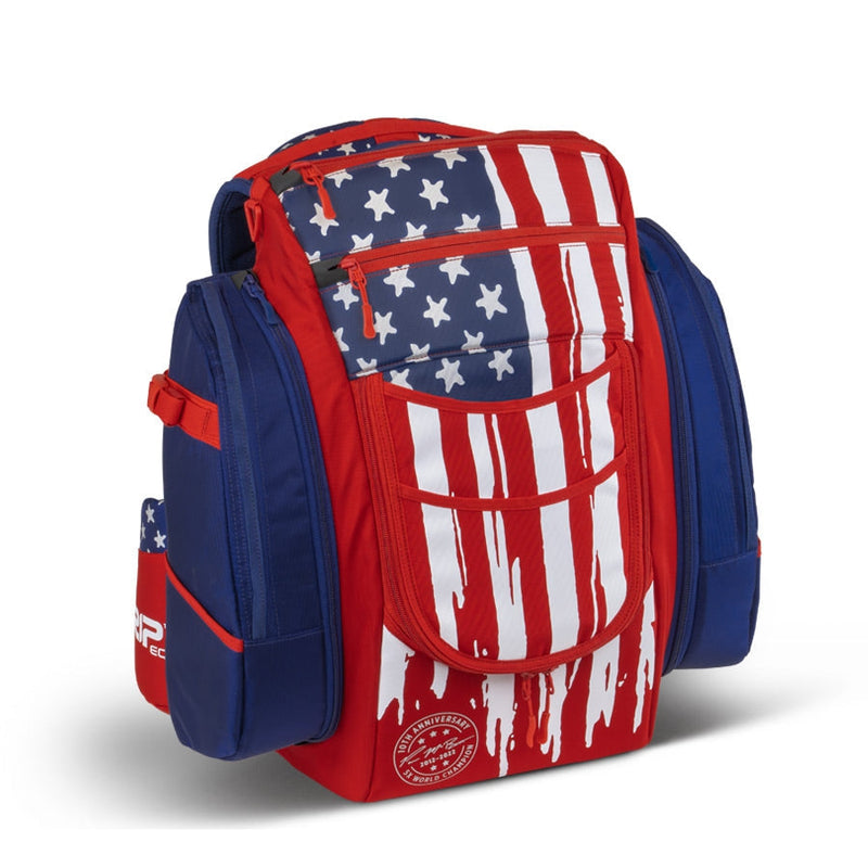Grip EQ BX3 Series Tour Bag backpack in red, white, and blue with a patriotic dripping flag design and zippered compartments.