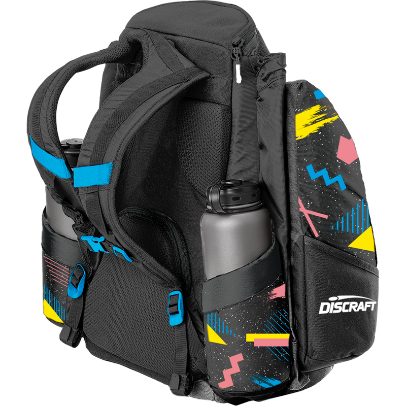 Black Grip EQ Discraft AX5 disc golf bag with colorful 90s-themed side panels and two gray water bottles.