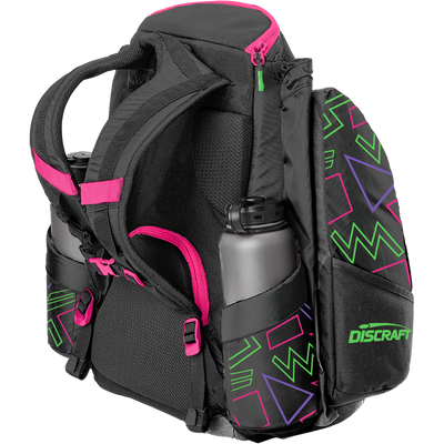 Black Grip EQ Discraft AX5 disc golf bag with hot pink accents and neon green and purple geometric patterns.