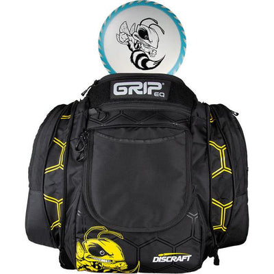 Black GRIP EQ AX6 disc golf bag with yellow honeycomb pattern and a Discraft Buzzz disc on top.