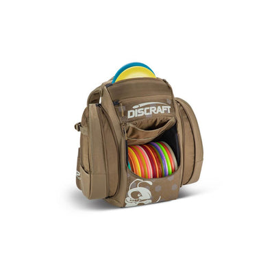 Brown Discraft Buzzz BX3 disc golf bag filled with colorful discs, featuring a Discraft logo pocket and puppy design.