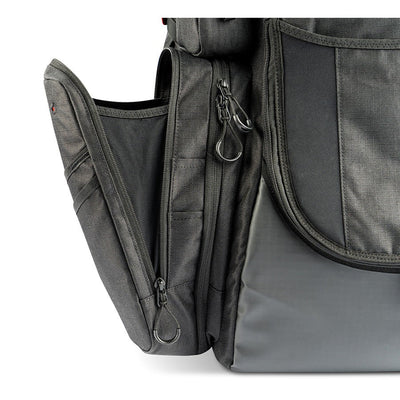 Black GRIP EQ Discraft Paul McBeth PX1 disc golf bag featuring multiple zippered compartments with ring pull tabs.