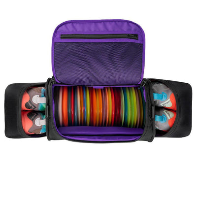Black GRIP EQ Discraft Paul McBeth TSD1 Travel Sport Duffle with purple lining, assorted discs, and shoes in side pockets.