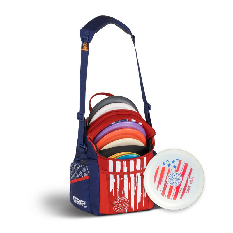 Blue and red GRIP EQ G2 Series Paul McBeth 10-Year Anniversary disc golf bag with discs and matching golf disc.